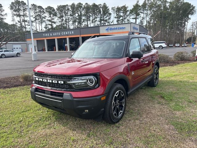 2026 Ford Bronco Sport Outer Banks in Ruby Red Metallic Tinted Clearcoat — front three-quarter view